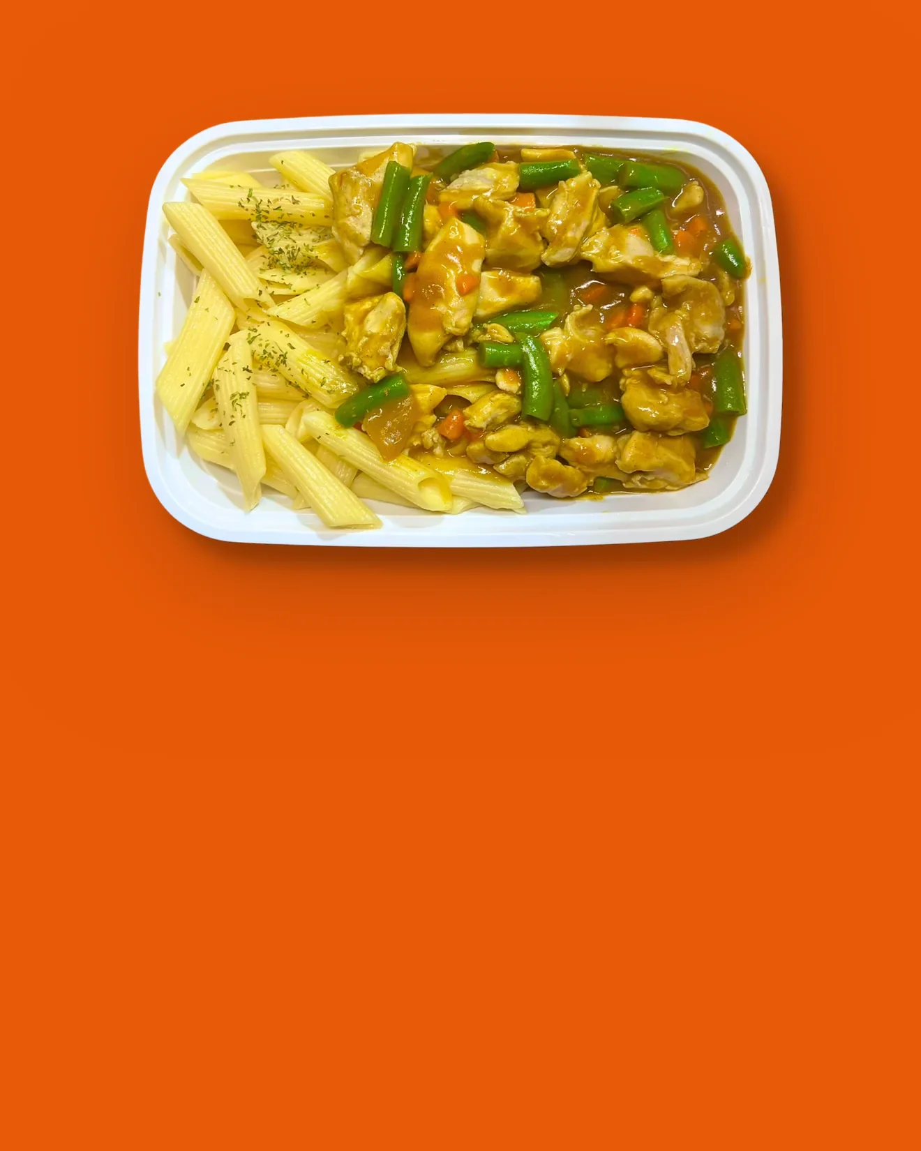 Overhead view of a GoBox Curry Chicken box served with a penne base